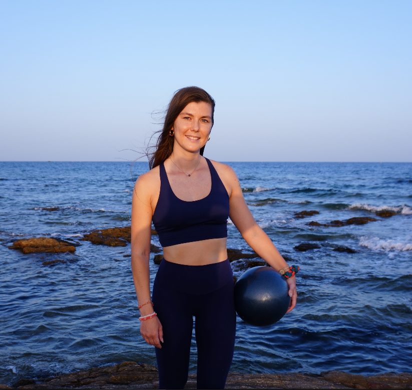 Join me on the beach for invigorating Pilates sessions while enjoying the serene surroundings. Discover the benefits of Pilates as I hold a Pilates ball against the backdrop of the ocean. Strengthen your body and mind in a harmonious environment.